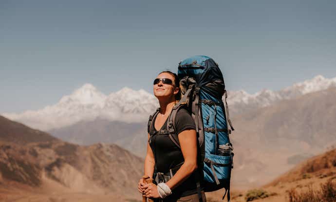 Woman hiking in the sun admiring the view