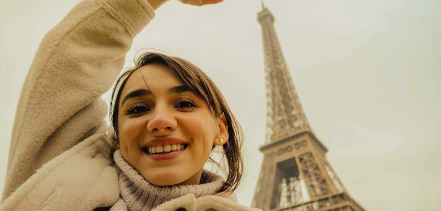 low angle portrait shot of a woman in front of the Eiffel Tower