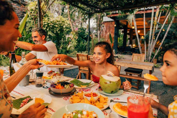 Family and young girl eating in Mexico