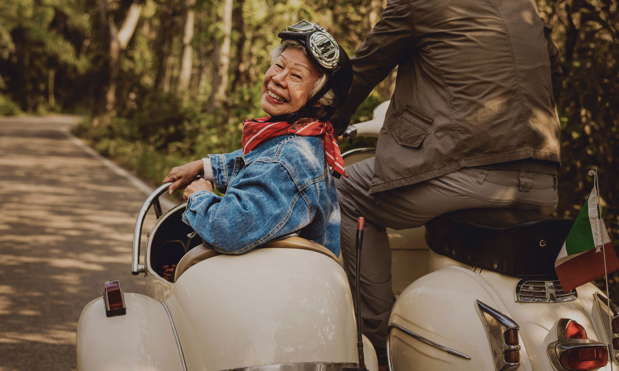 Senior couple riding a motorbike with a sidecar