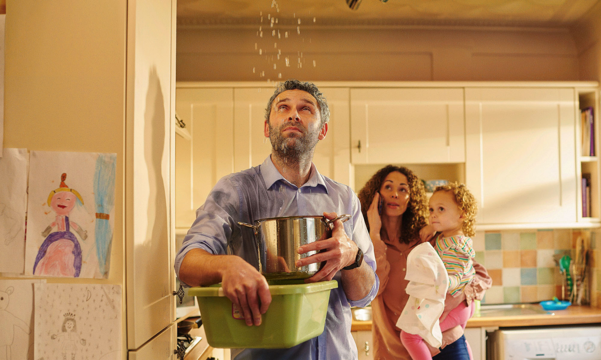 Family observing water dripping from the ceiling